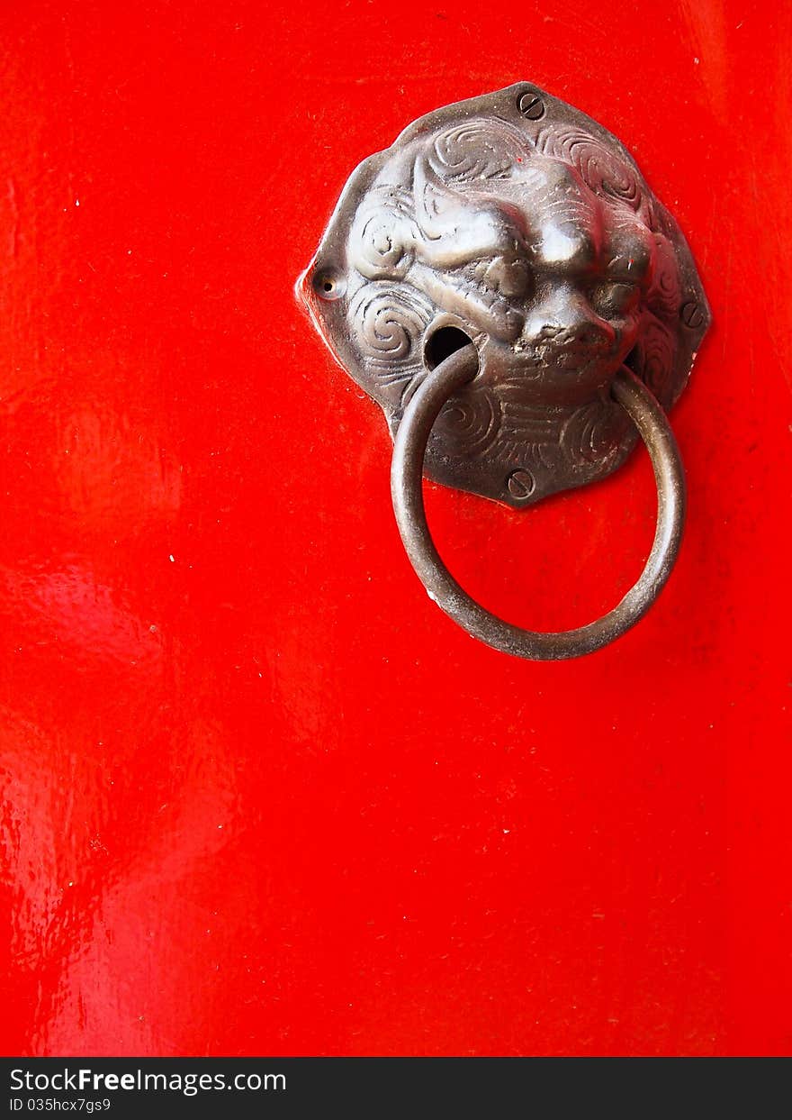 Red chinese door with a lion/dragon head