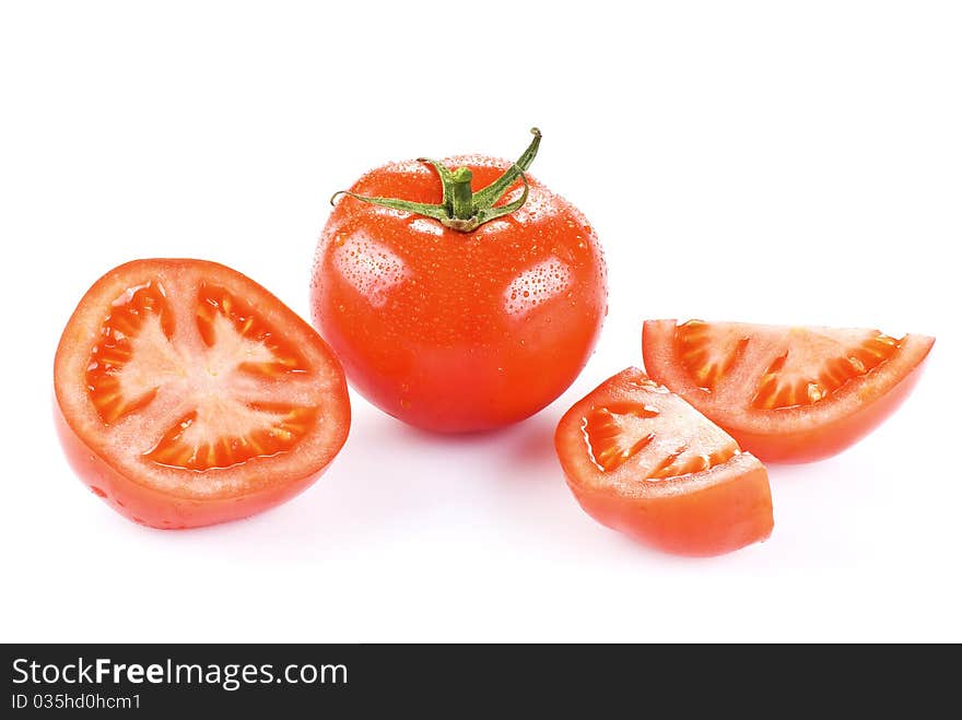 Fresh tomato with one half and two quarters over white. Fresh tomato with one half and two quarters over white