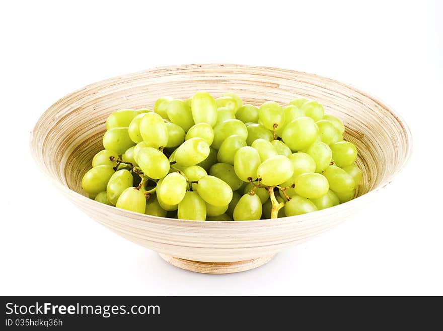 Grape fruits in wooden bowl - isolated over white. Grape fruits in wooden bowl - isolated over white