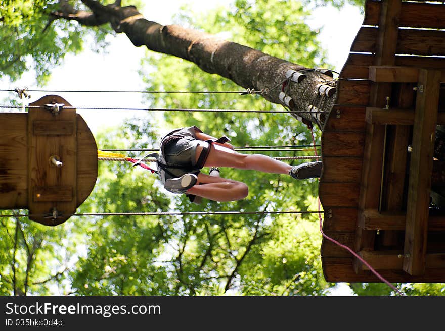 Woman jumps high up on a wooden platform. Woman jumps high up on a wooden platform