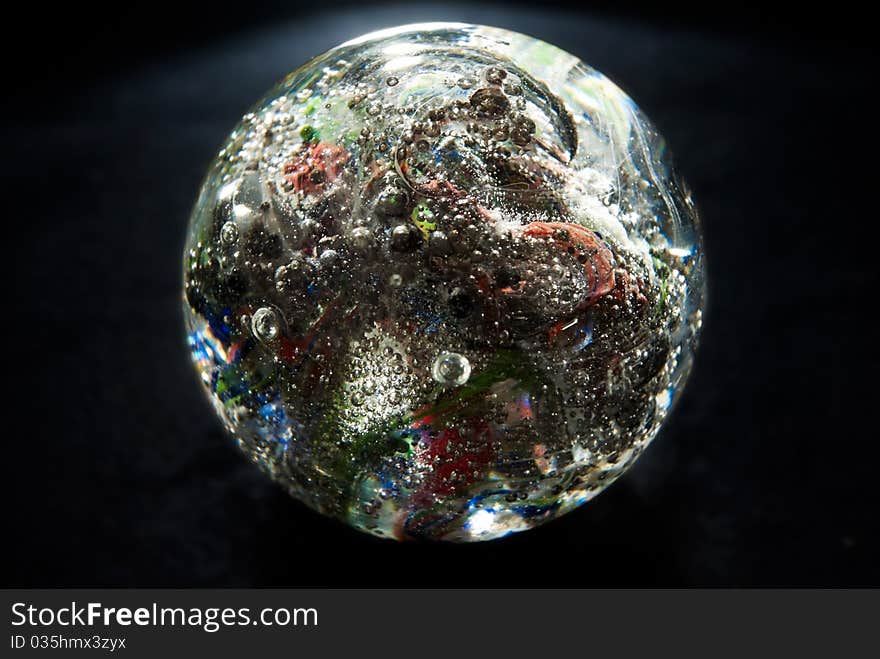 Crystal glowing sphere with bubbles, on black