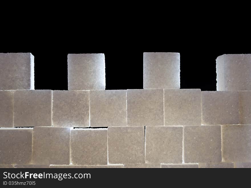 A wall with castellation made from sugar cubes, backlight. A wall with castellation made from sugar cubes, backlight