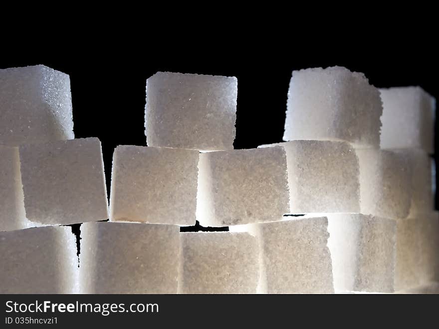 A top of tower made from sugar cubes, backlight. A top of tower made from sugar cubes, backlight