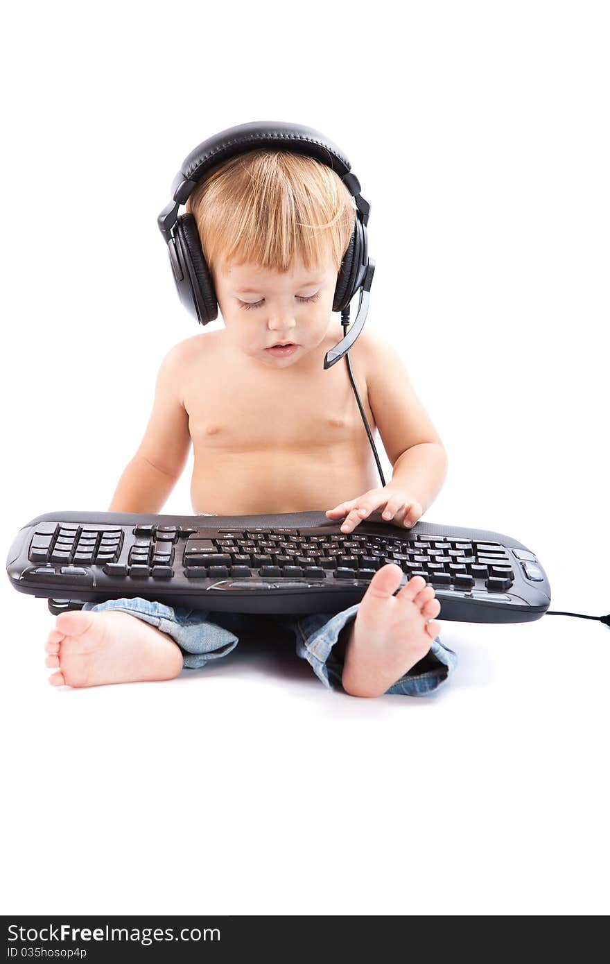 Little boy with headphones and keyboard. Little boy with headphones and keyboard