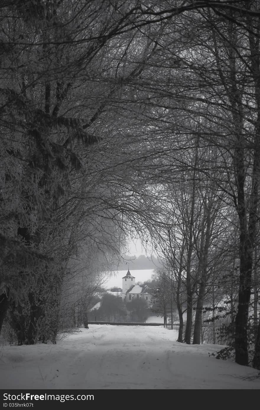 Little church in winter with a snowy alley in front. Little church in winter with a snowy alley in front