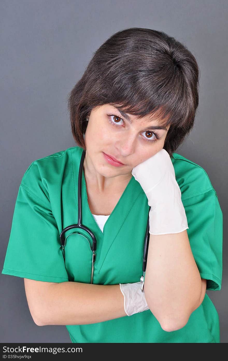 Attractive lady doctor on a over gray background