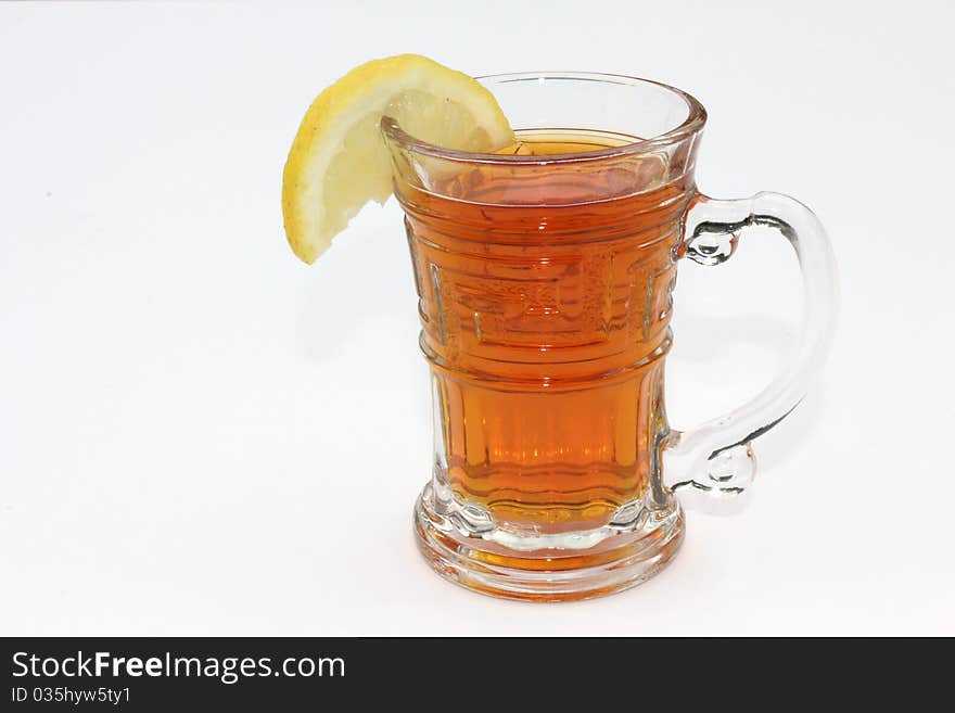 Cup of tea with a slice of lemon in a clear glass