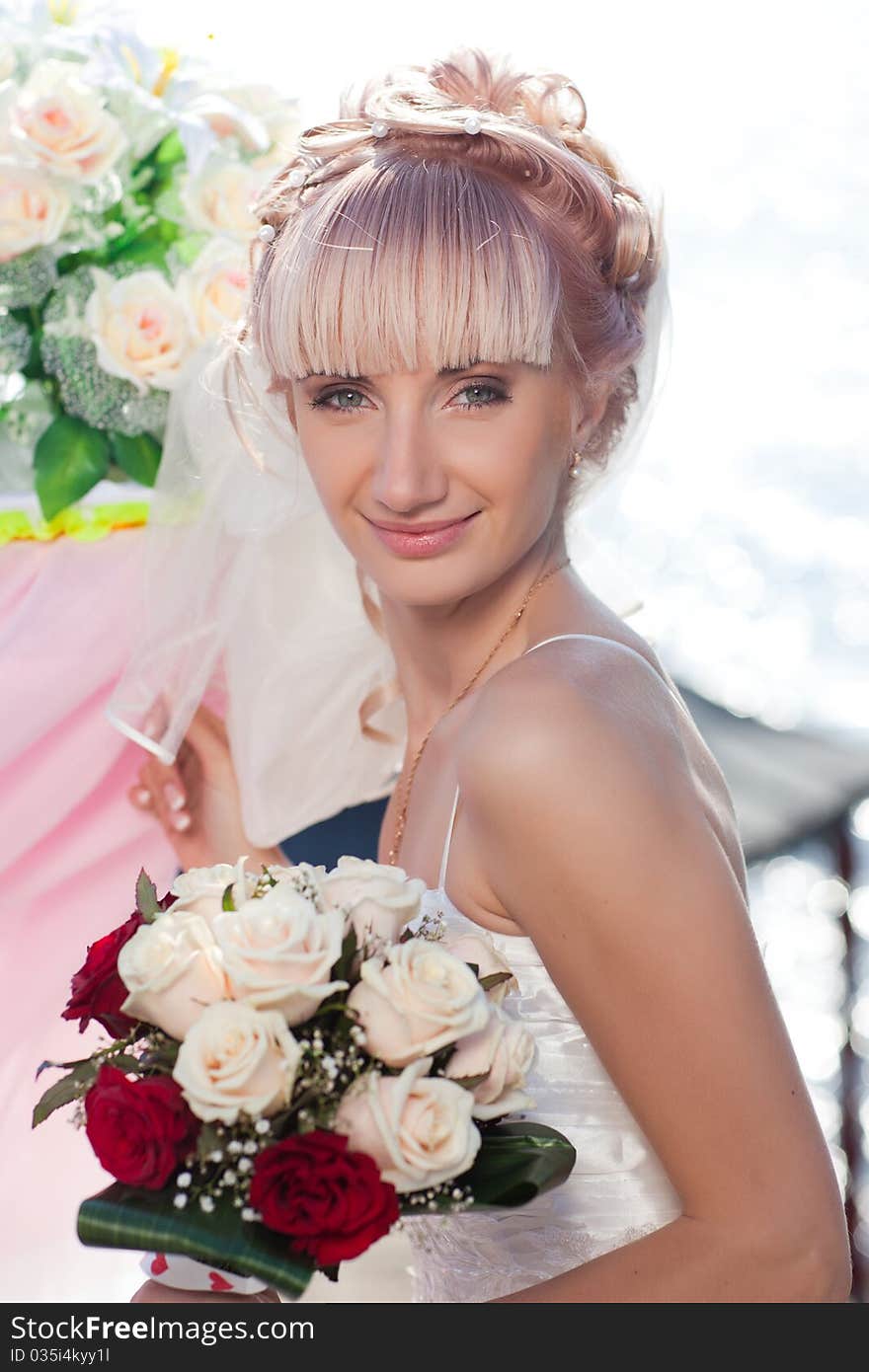 Happy caucasian bride posing with wedding bouquet. Happy caucasian bride posing with wedding bouquet