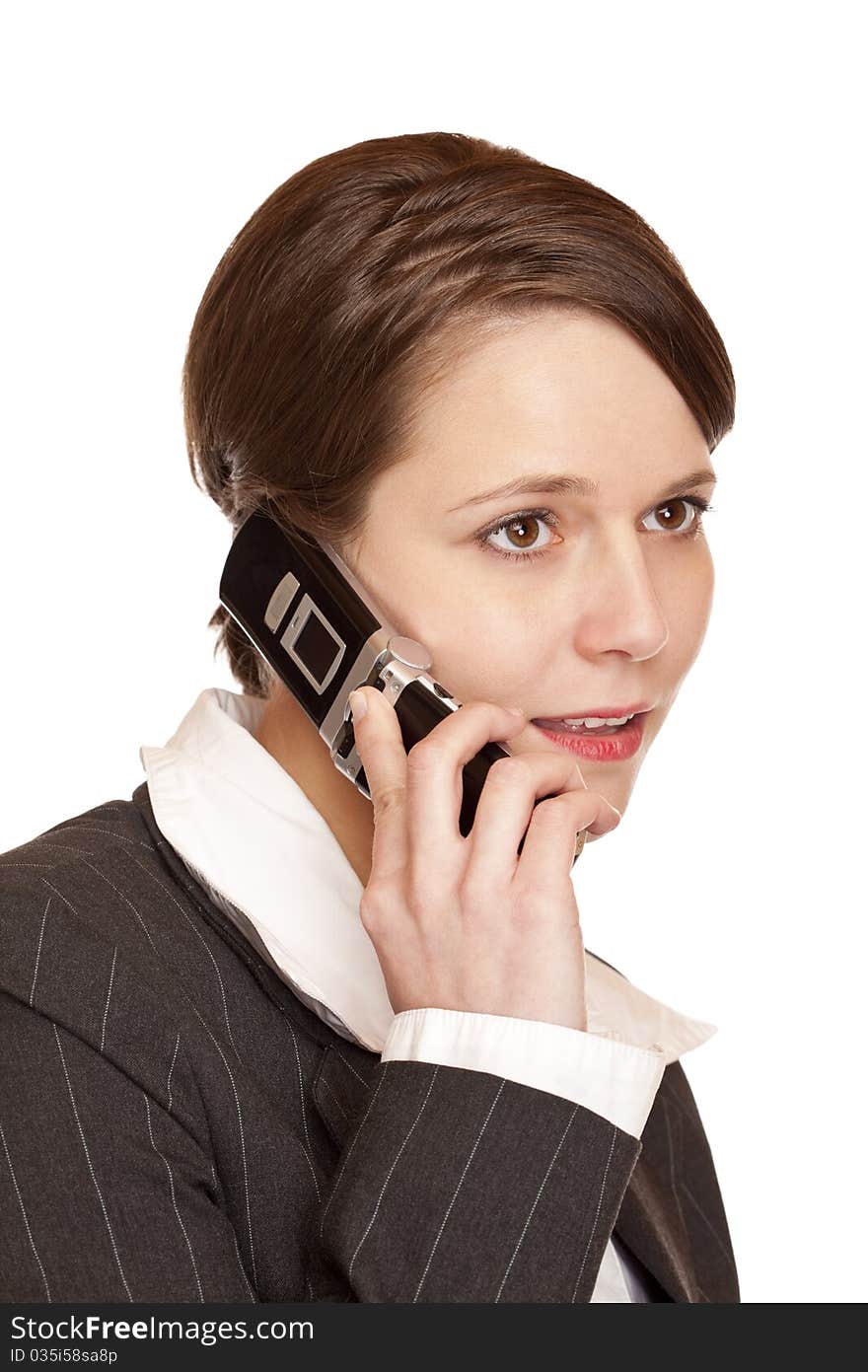 Young attractive business woman talks on the telephone. Isolated on white background.