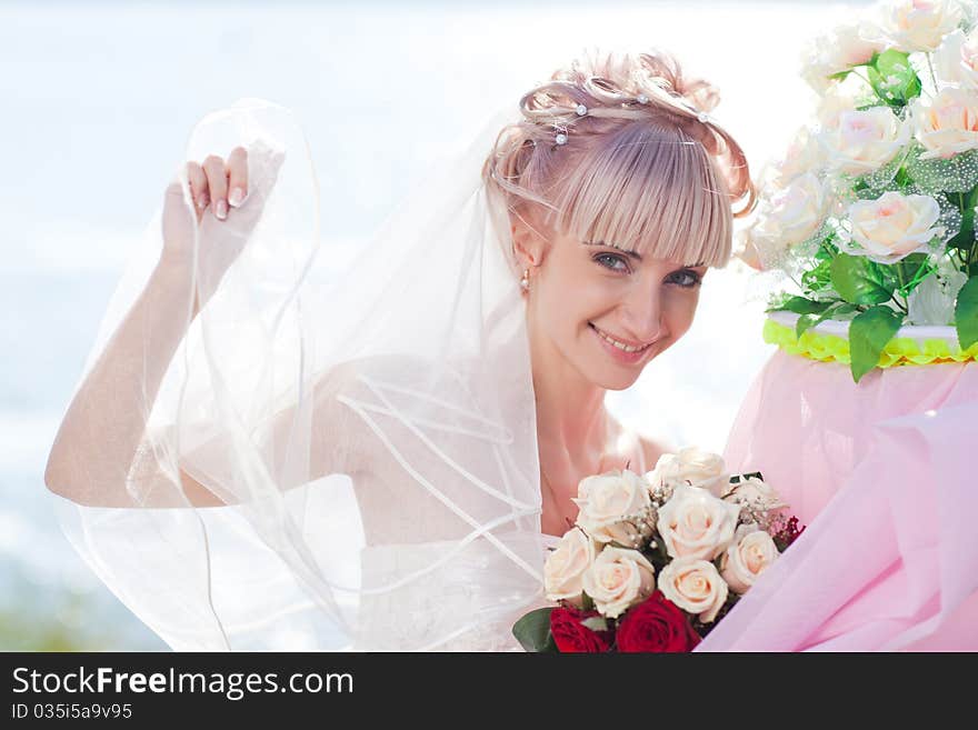 Beautiful young bride posing to the camera with pretty smile. Beautiful young bride posing to the camera with pretty smile