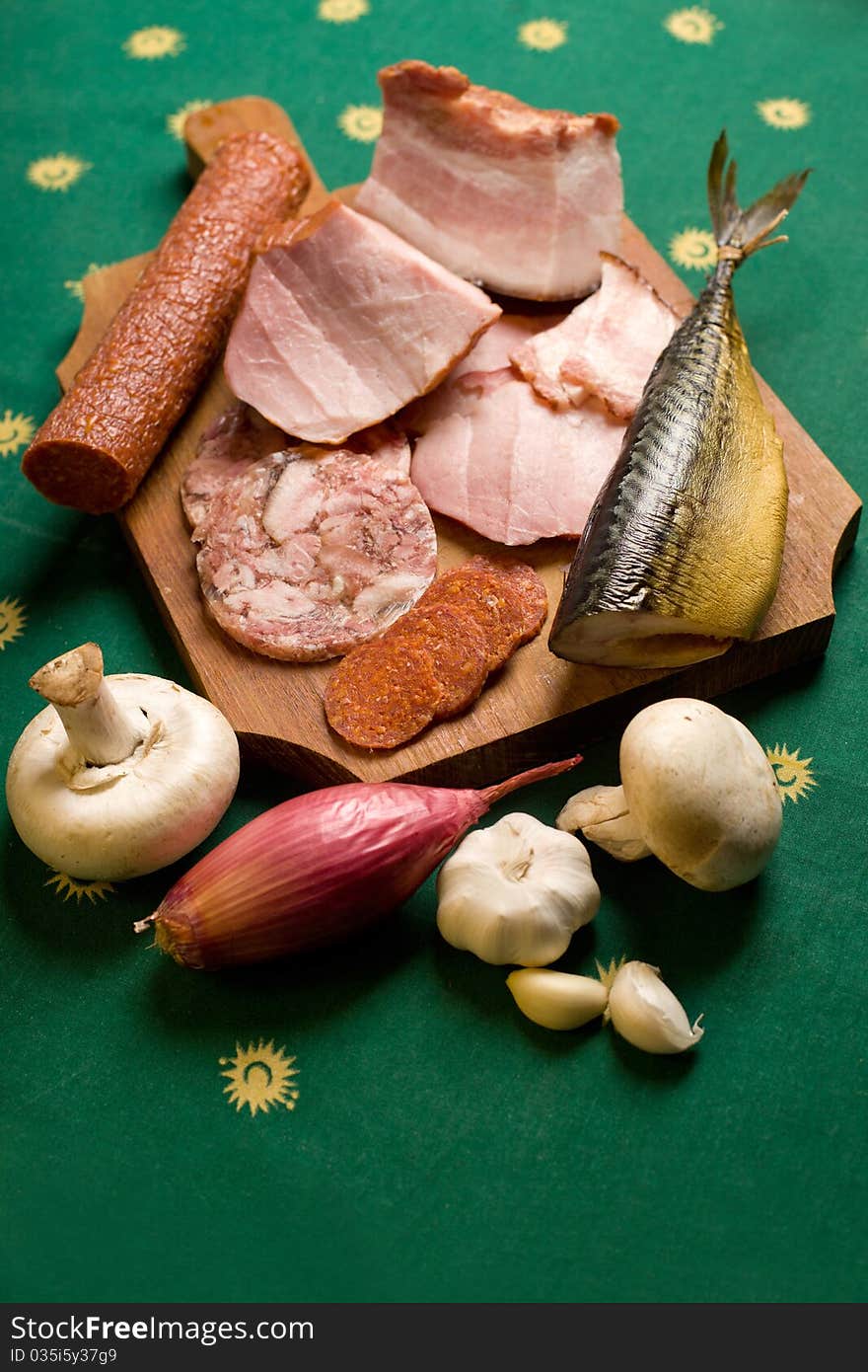 Assortment of meat appetizers on green tablecloth