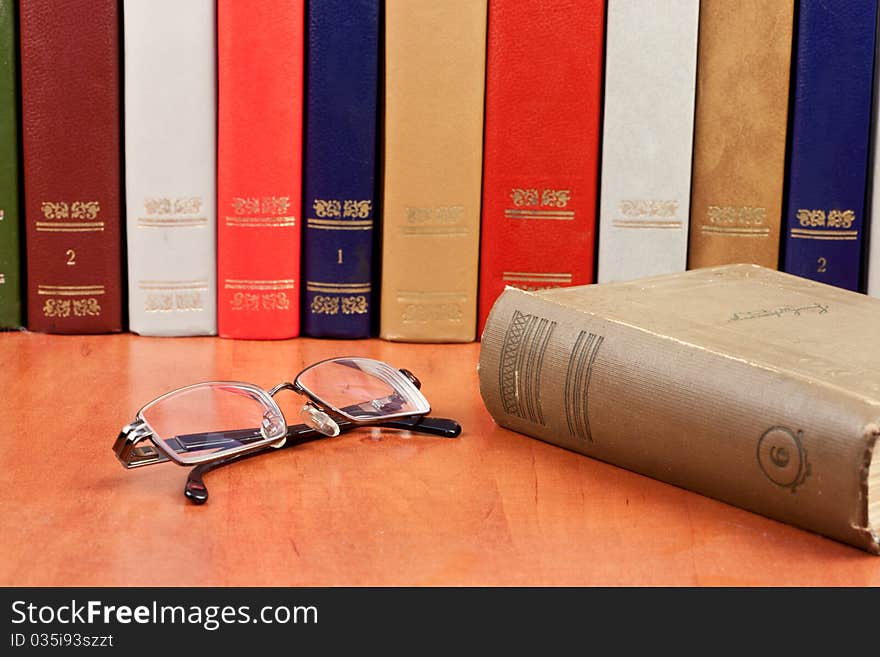 Glasses With Old Hardcover Books