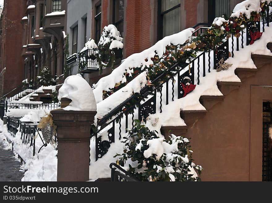 Christmas decorations on railing of New York Brownstone after snow storm. Christmas decorations on railing of New York Brownstone after snow storm