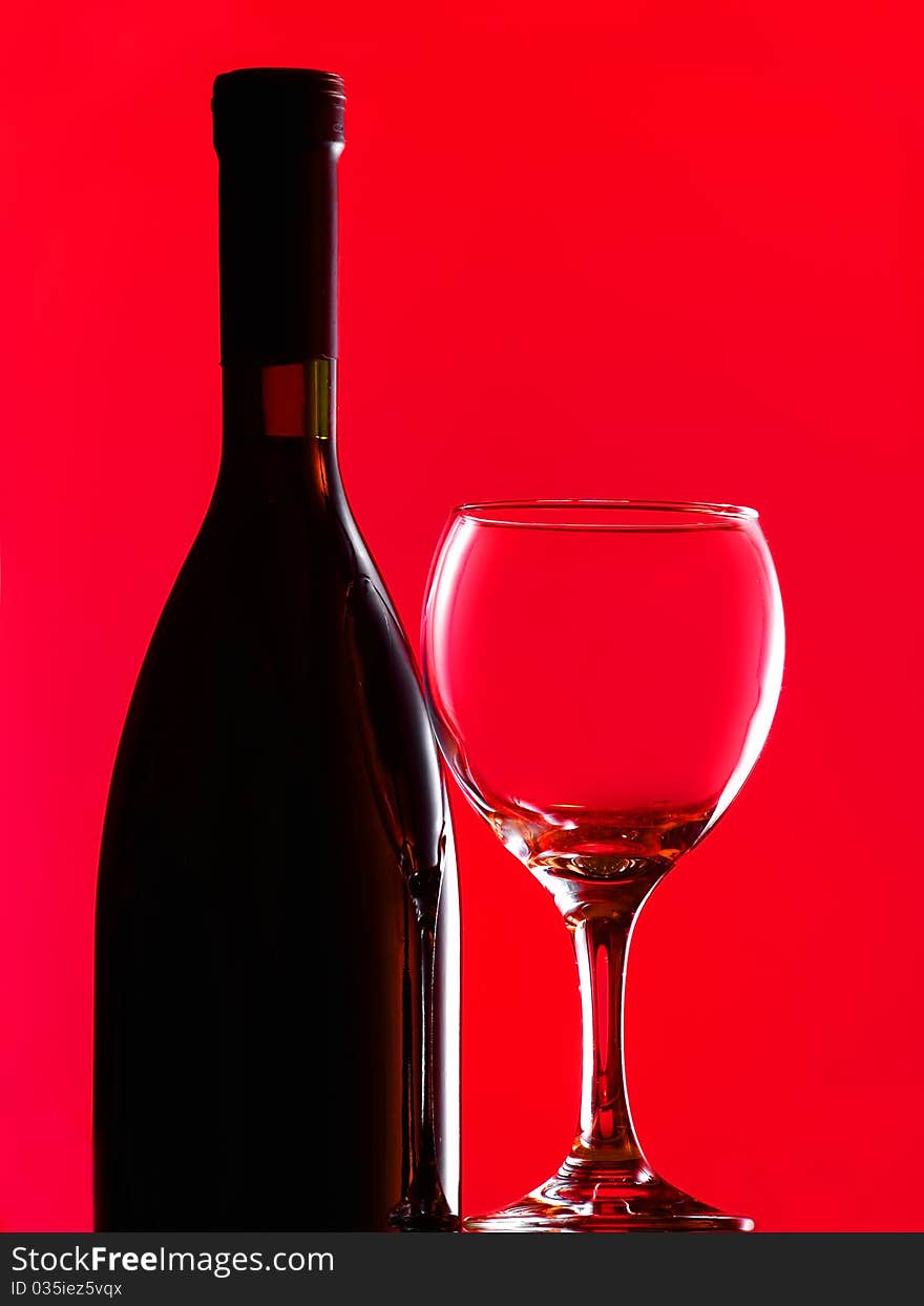 Bottle and glass over red background. Bottle and glass over red background