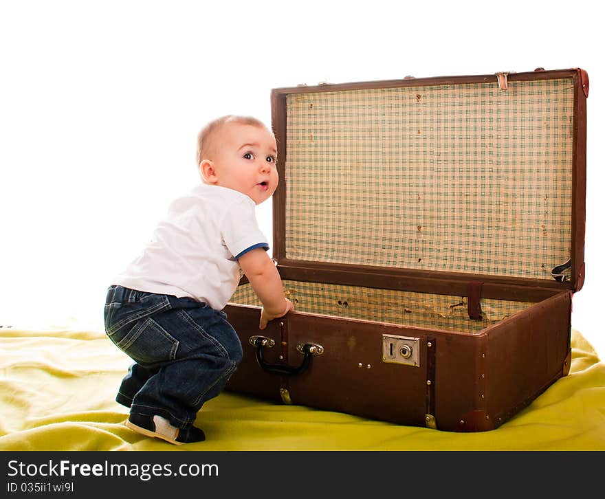 Little boy sitting near an old suitcase. Little boy sitting near an old suitcase