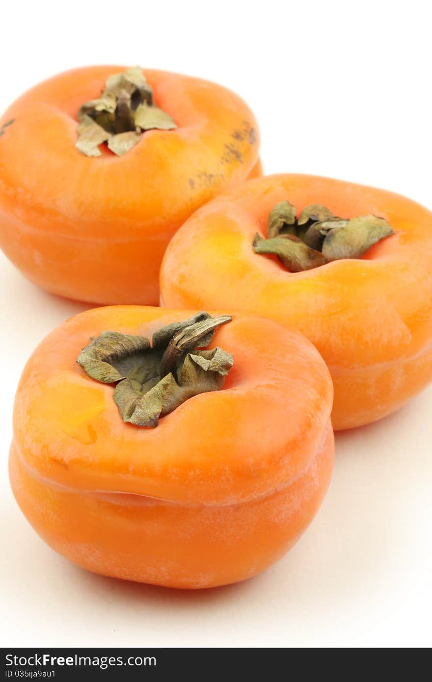 3 Persimmon on a white background close-up lens