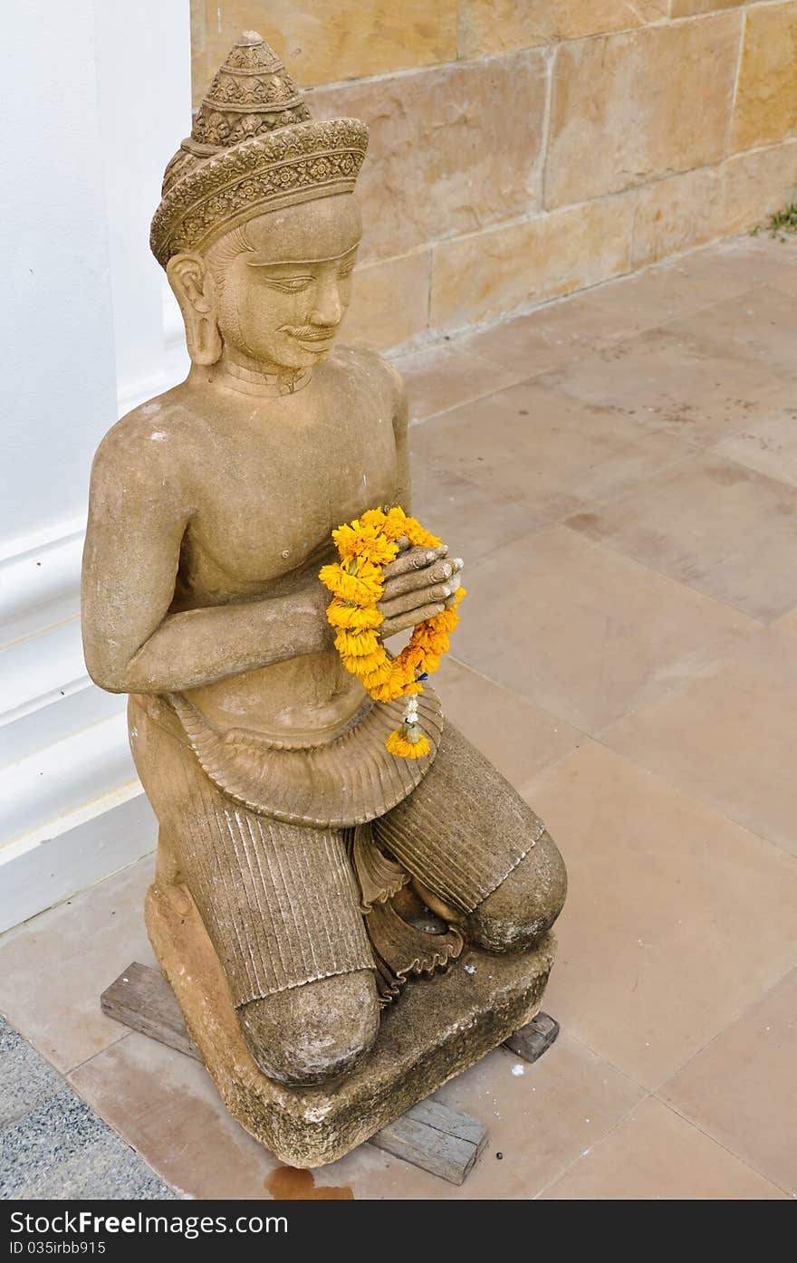 Thai style statue in front of a temple