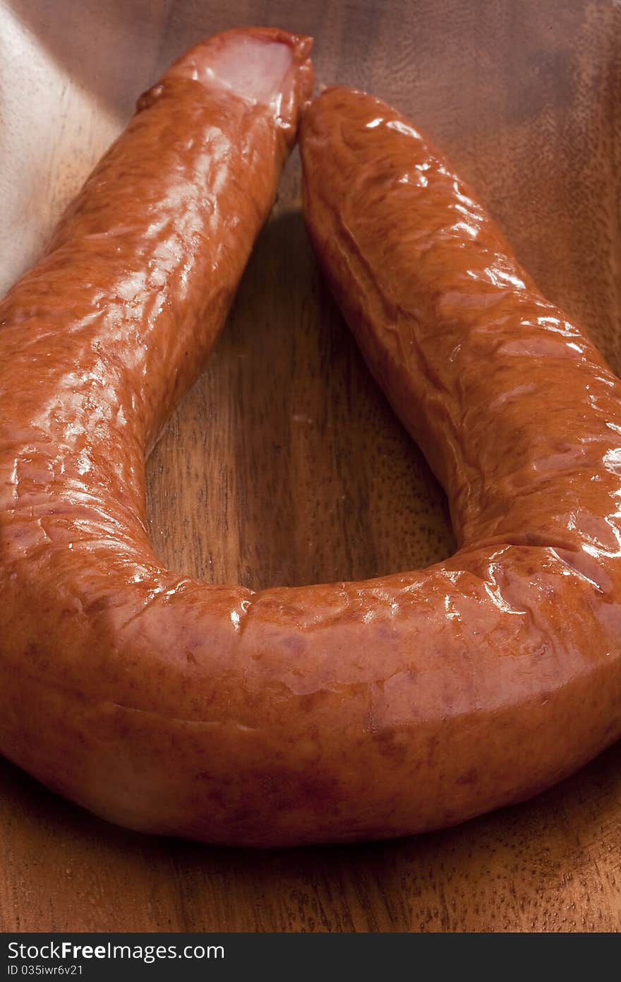 Home smoked sausage in a wooden bowl.