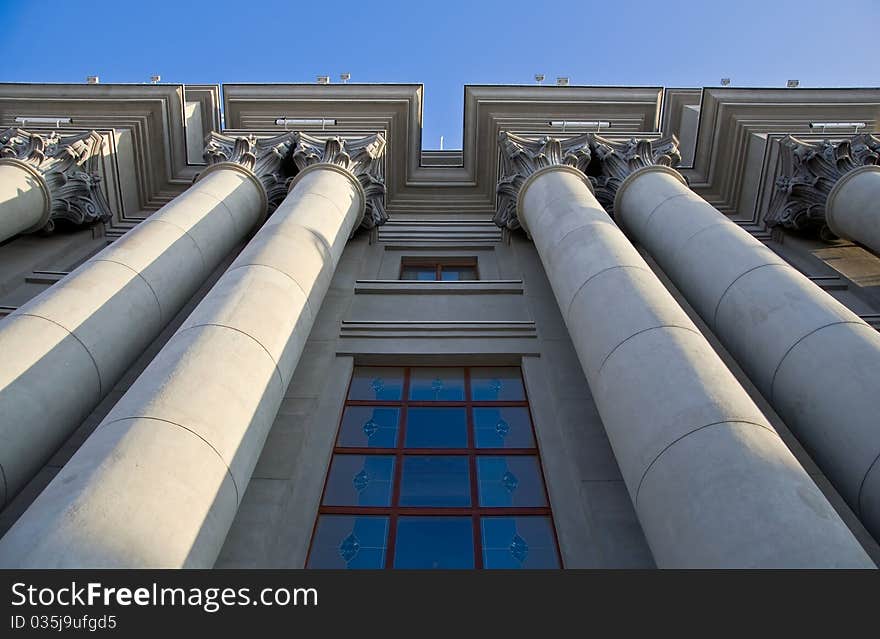 Stalinist architecture. Corinthian capitals and columns. Prospectively on a background of blue sky.