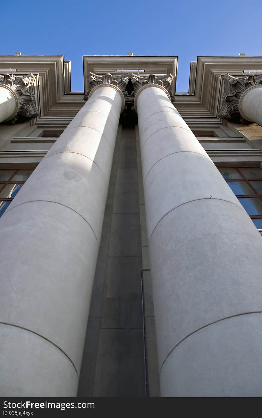 Stalinist architecture. Corinthian capitals and columns. Prospectively on a background of blue sky.