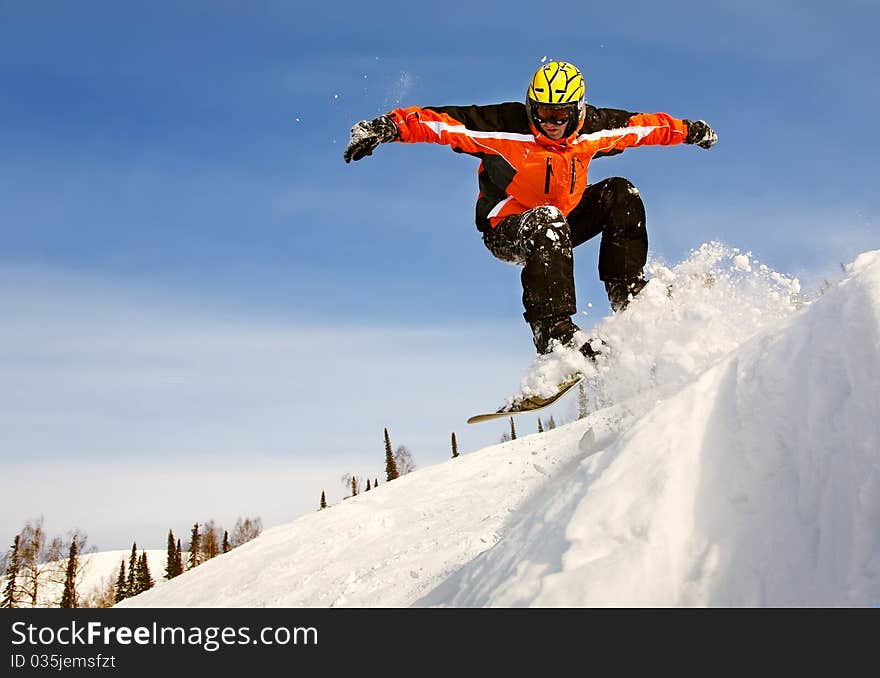 Snowboarder jumping through air with deep blue sky in background