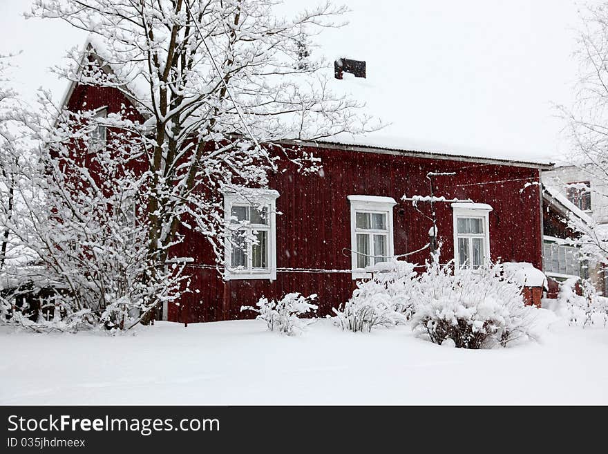 Winter Rural House Under Snowfall