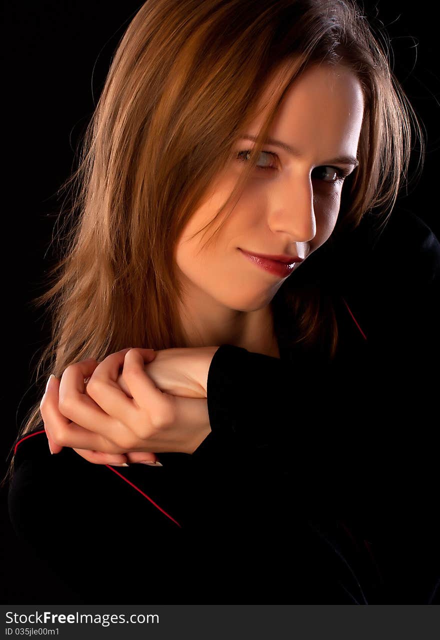 Happy young woman in black with her hands folded