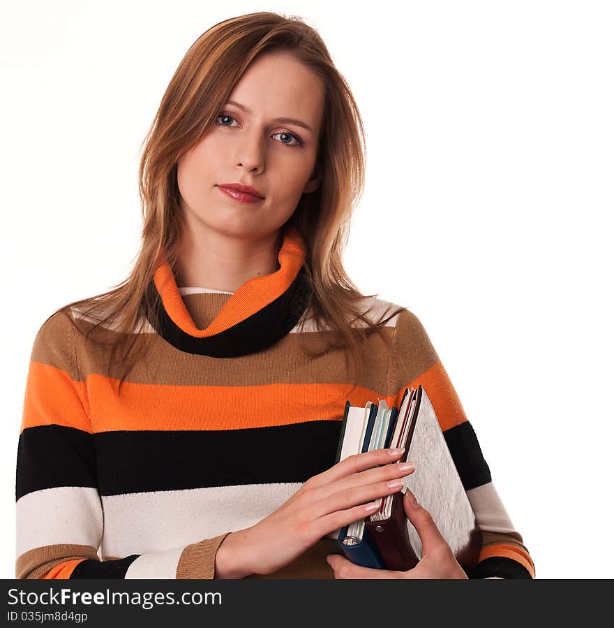 Young woman holding books under her arm on white background