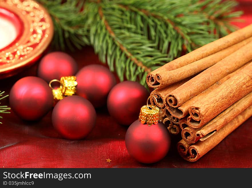 Christmas decorated table - red baubles and aromatic cinnamon. Christmas decorated table - red baubles and aromatic cinnamon