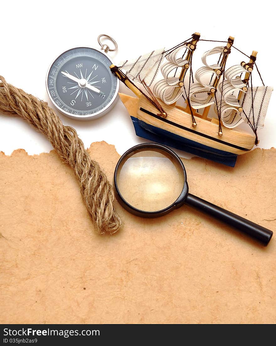 Rope, loupe, compass and model classic boat