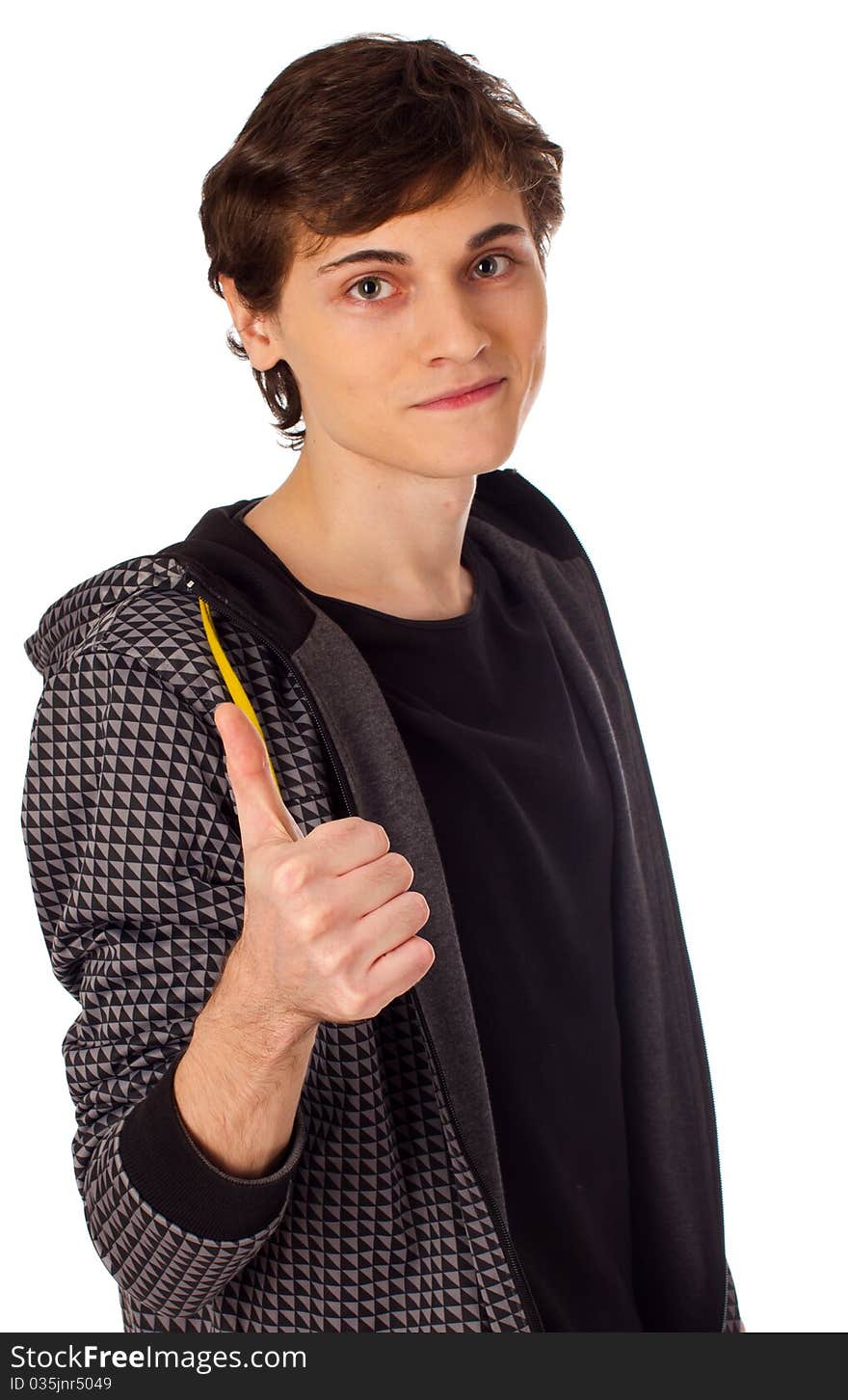 Young man standing looking at camera with thumbs up gesture. Young man standing looking at camera with thumbs up gesture