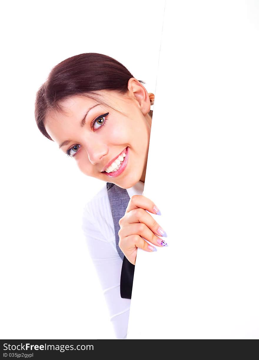 Pretty young brunette businesswoman hiding behind a big blank sheet of paper