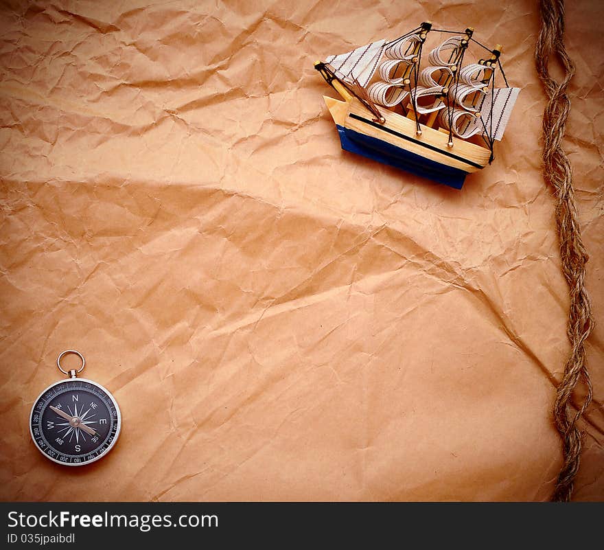 Compass  and model classic boat on grunge background. Compass  and model classic boat on grunge background