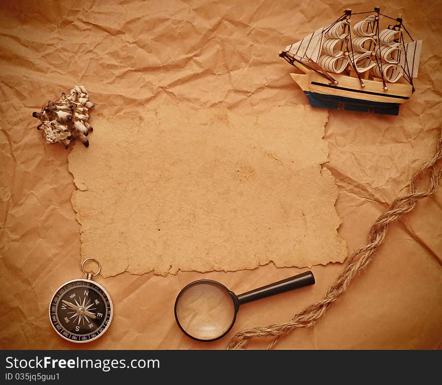 Loupe, rope and model classic boat on old paper