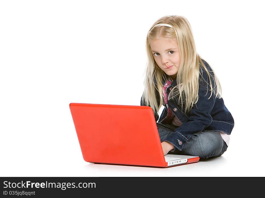 Cute little girl sitting down using laptop. Cute little girl sitting down using laptop