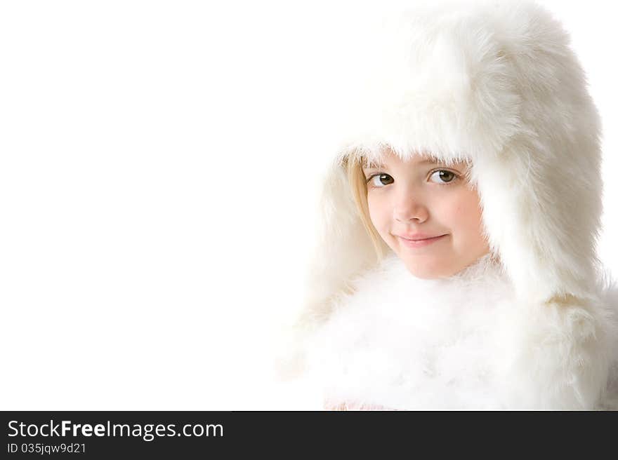 Little girl wearing a white fur hat and coat