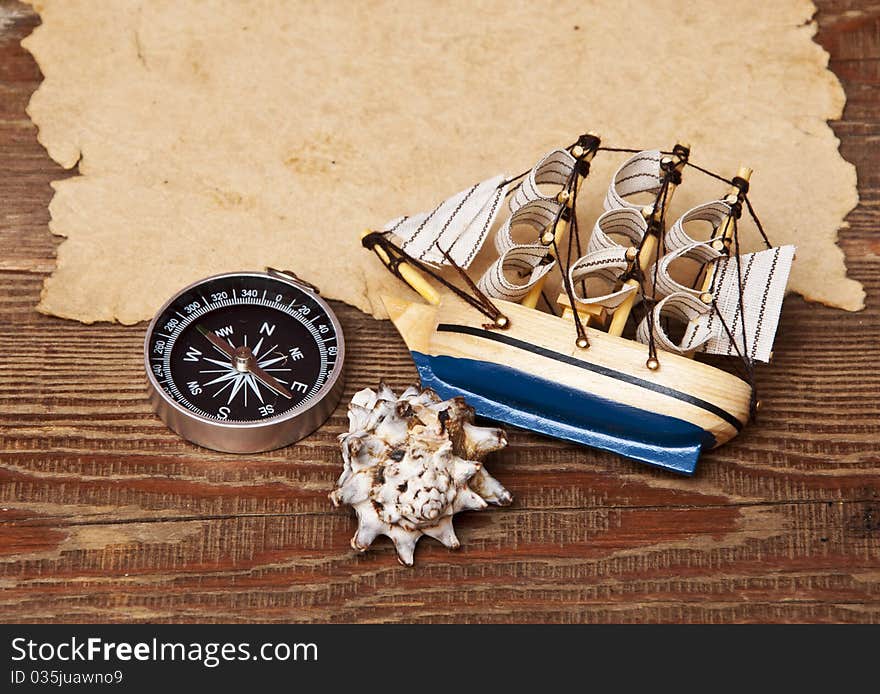 Old paper and model classic boat on wood background