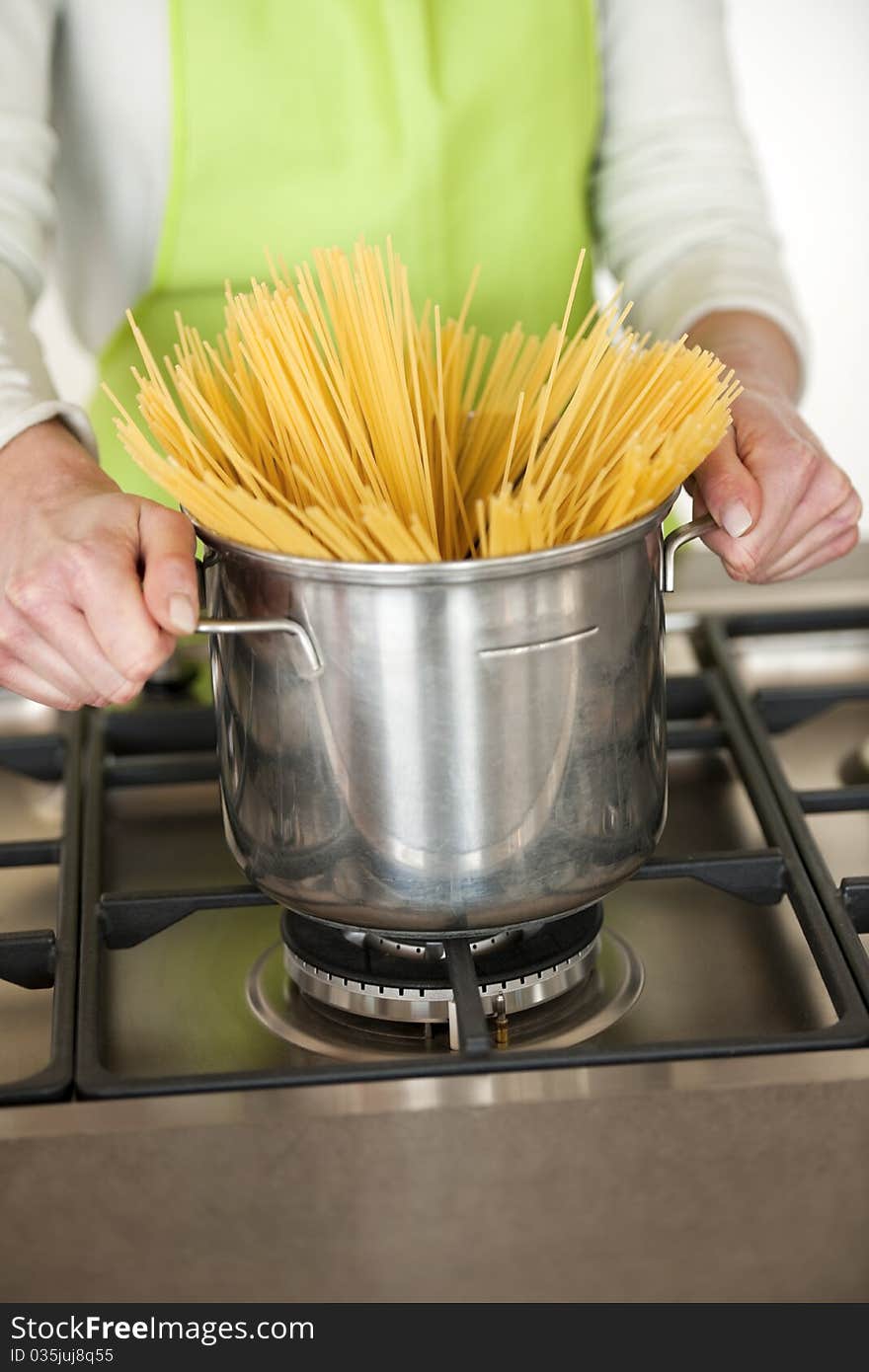 Woman Preparing Spaghetti In Pot, close-up