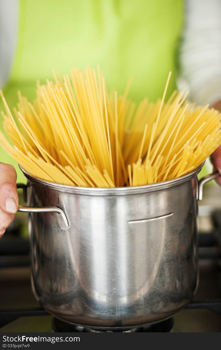 Woman Preparing Spaghetti In Pot