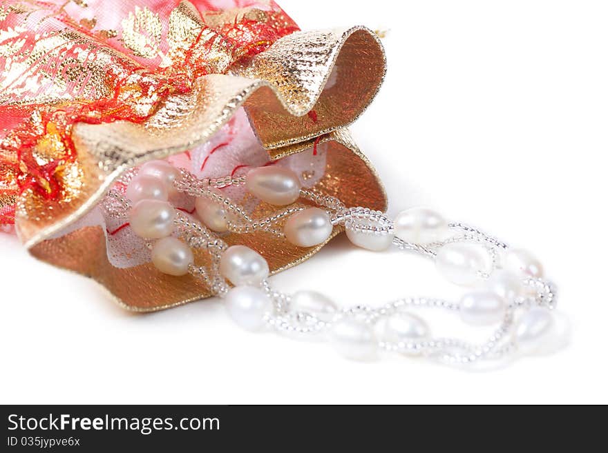 Closeup view of necklace with pearls and gift bag