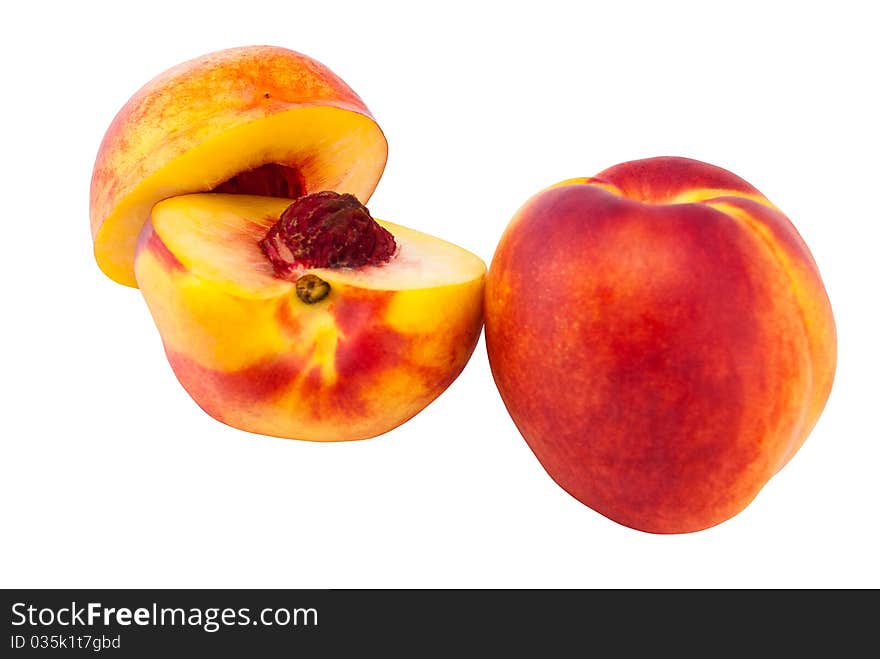 Whole and sliced nectarines isolated on white background