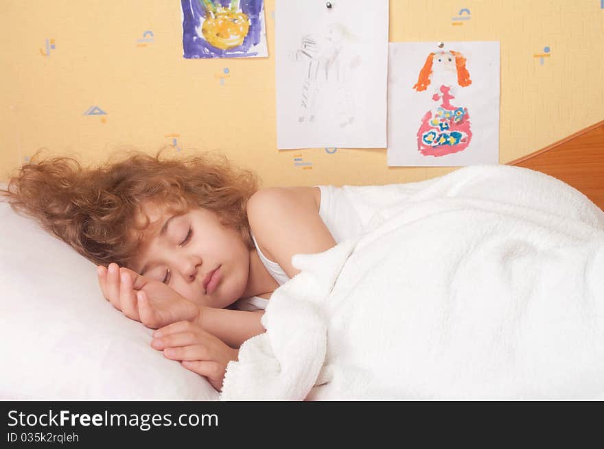 Sleeping little girl on bed