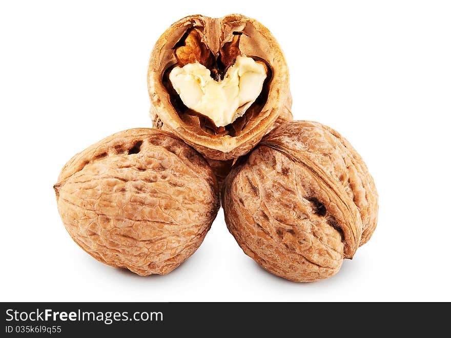 Two whole and chopped walnuts isolated on a white background