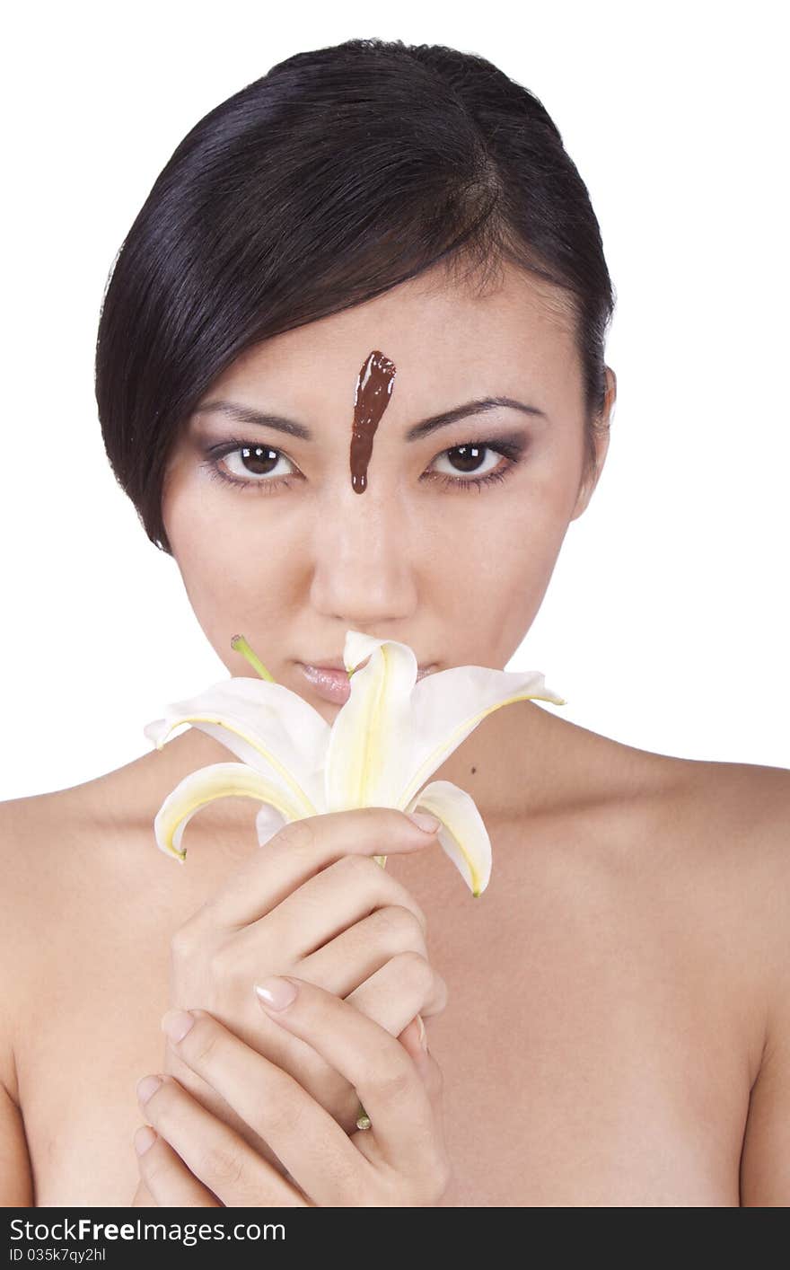 Girl with a lily and a drop of chocolate on his face. Girl with a lily and a drop of chocolate on his face.