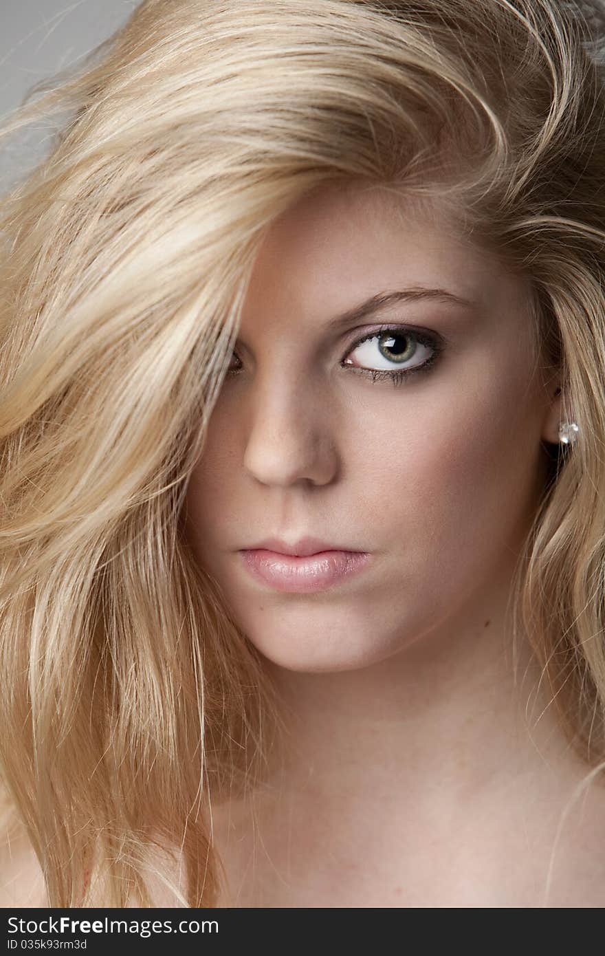 Intense close-up of pretty blond teenage girl with big eyes and beautiful hair. Intense close-up of pretty blond teenage girl with big eyes and beautiful hair