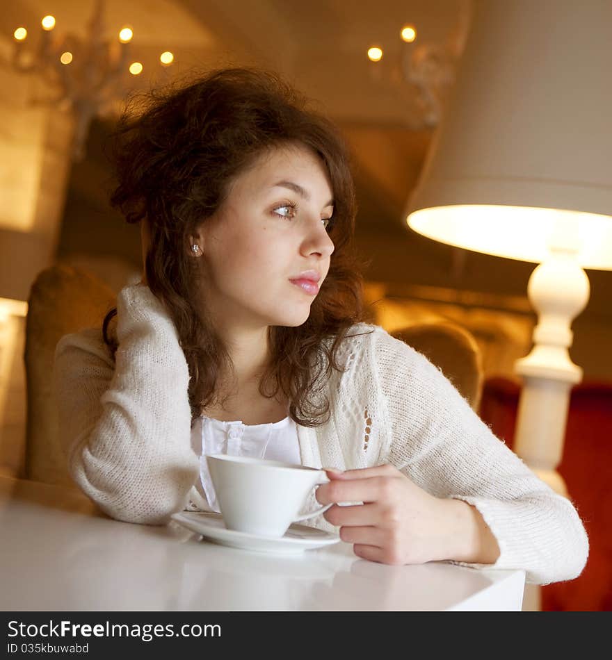 Young Woman Enjoying Latte Coffee In Cafe