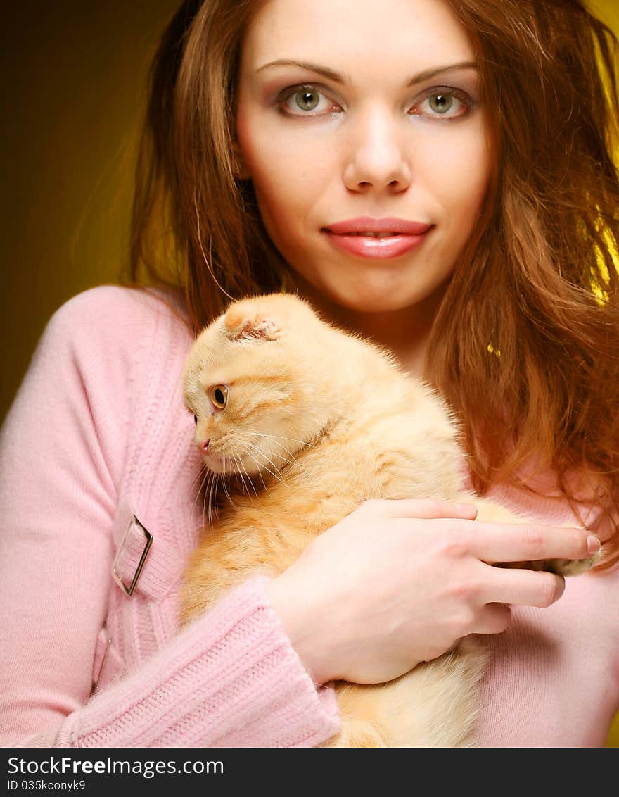 Young woman with red England lop-eared kitten