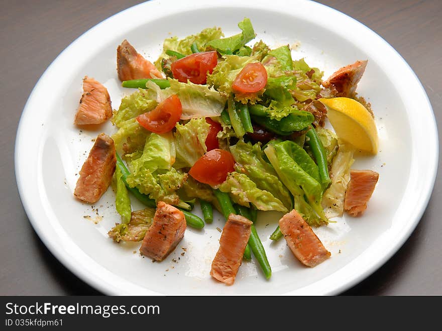 Salad with fresh vegetables, grilled salmon and asparagus