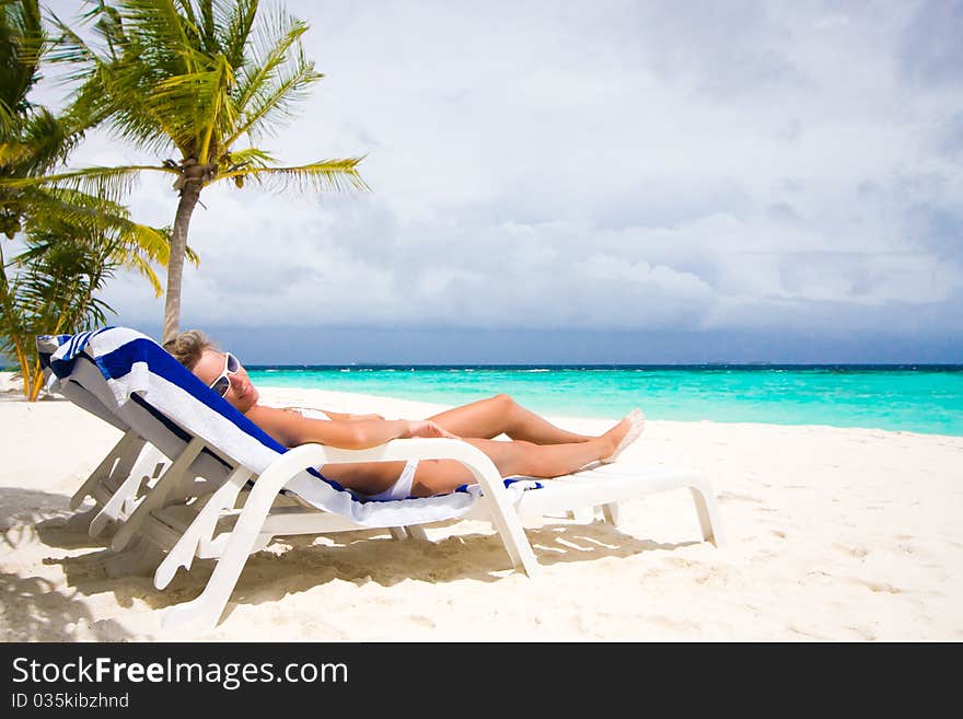 Lady relaxing in the chaise lounge