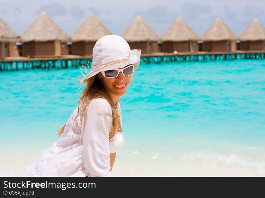 A girl is in white on a beach. A girl is in white on a beach